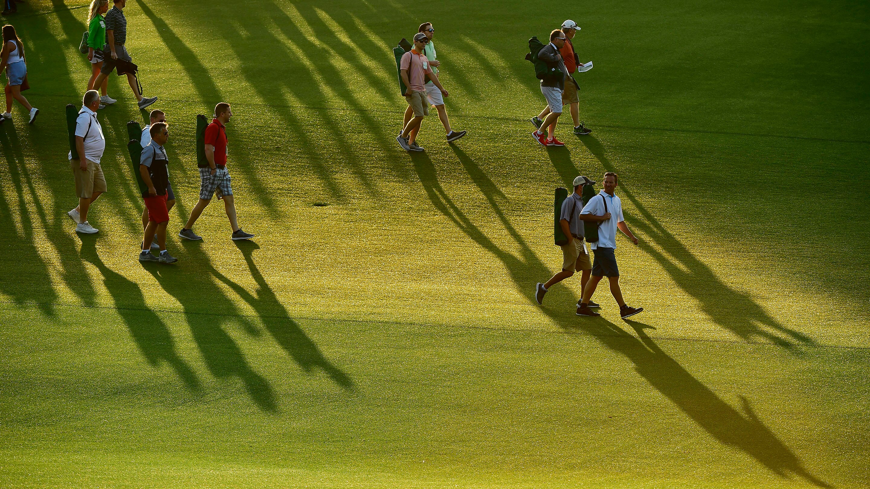 the-shadows-of-masters-patrons-precede-them-on-the-no-1-hole-during