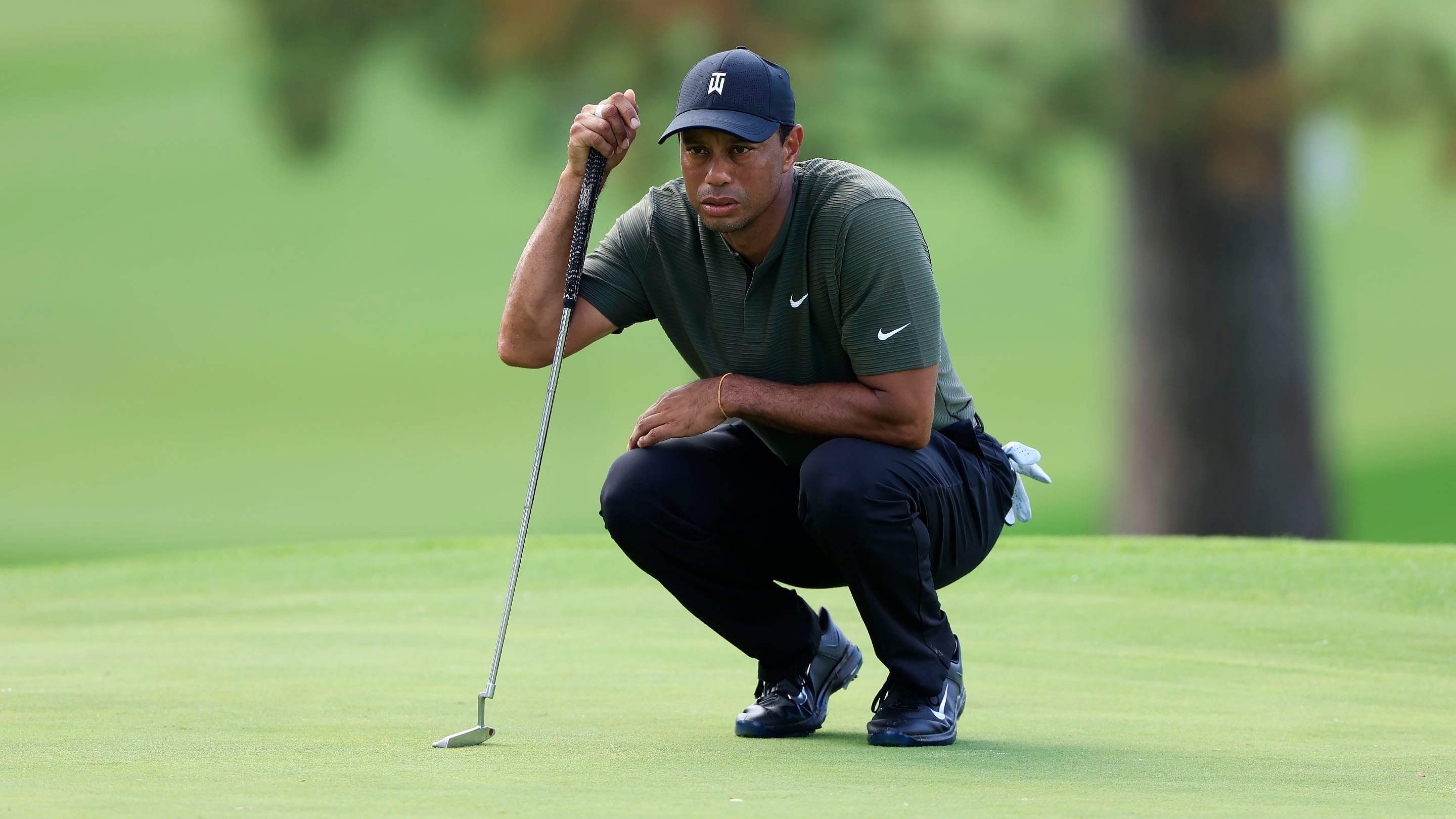 Masters champion Tiger Woods reads the No. 7 green during the first round of the 2020 Masters.