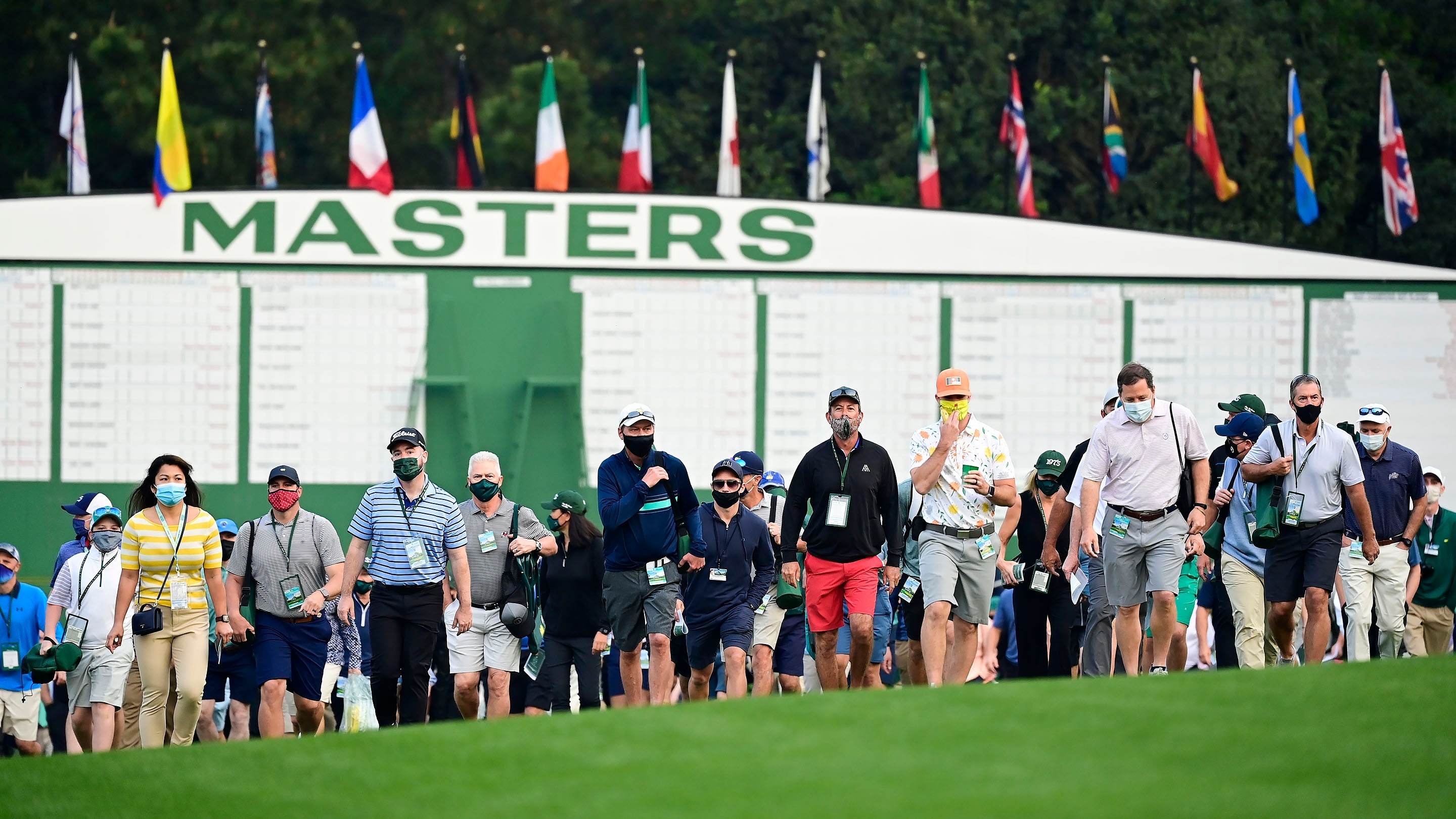Patrons head to the No. 1 tee during Round 1 of the Masters at Augusta ...