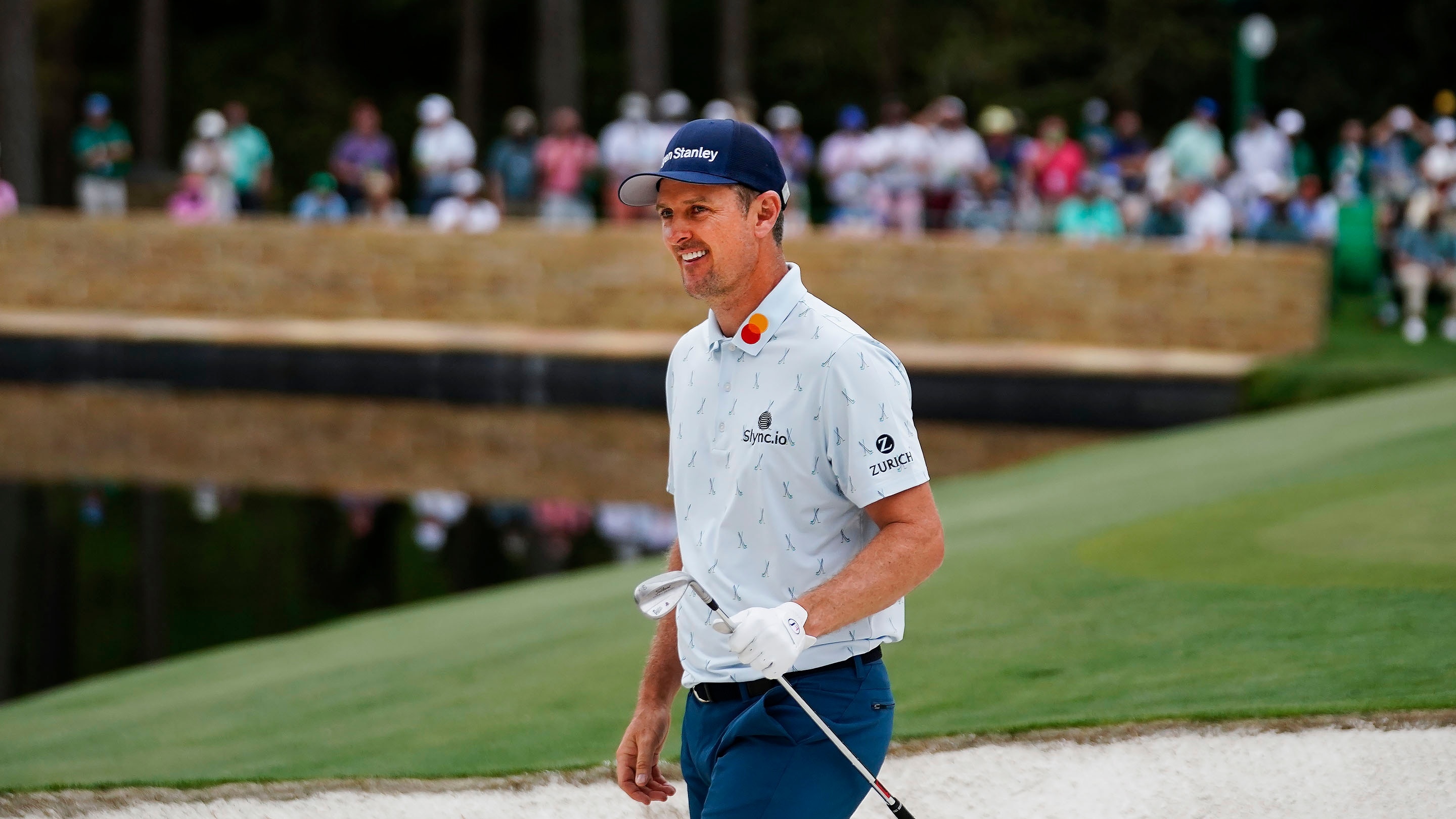 Justin Rose of England smiles after his bunker stroke on No. 15 during Round 1 of the Masters at
