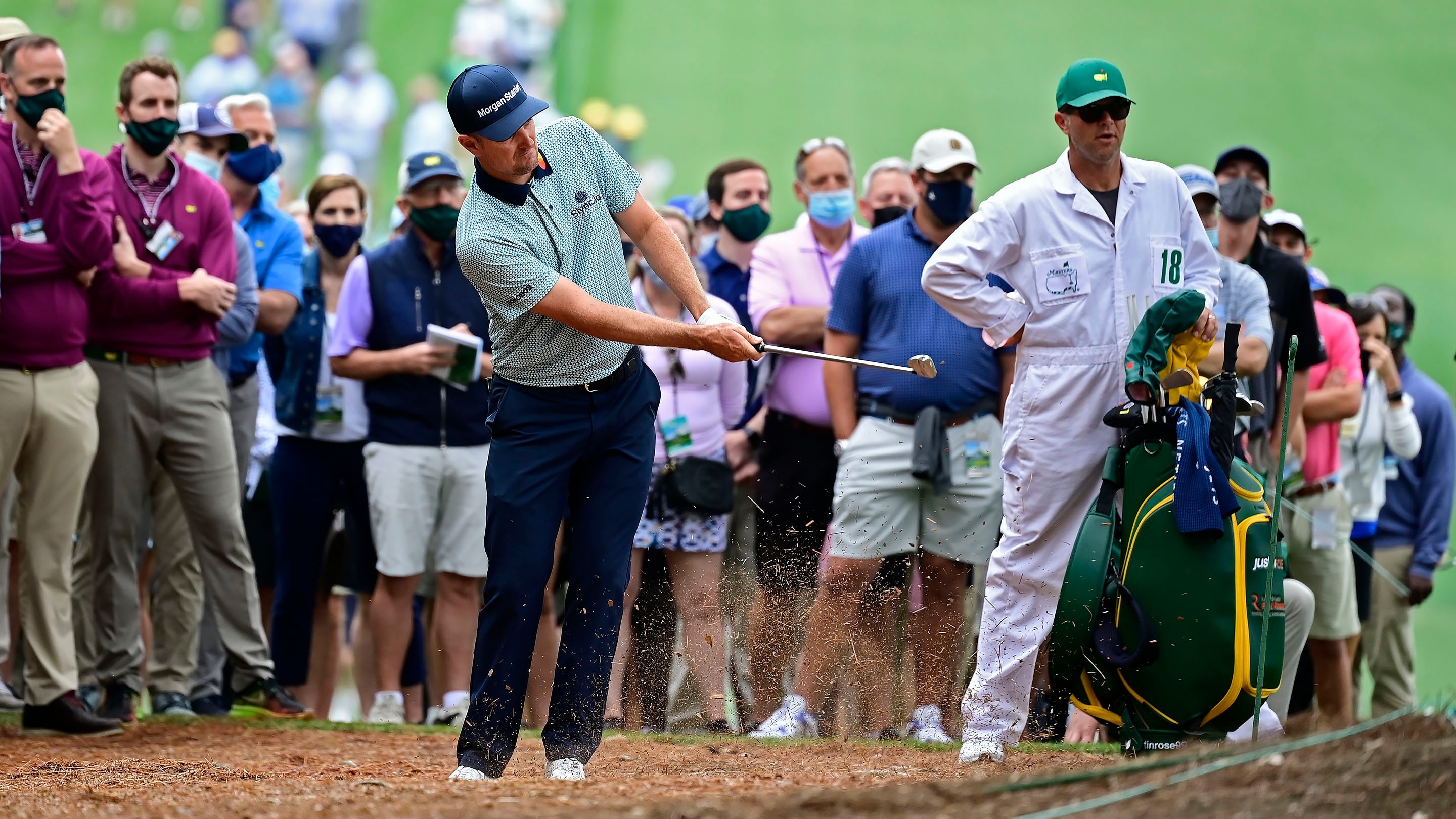 Justin Rose of England uses an iron from the pine straw at No. 1 during Round 2 of the Masters