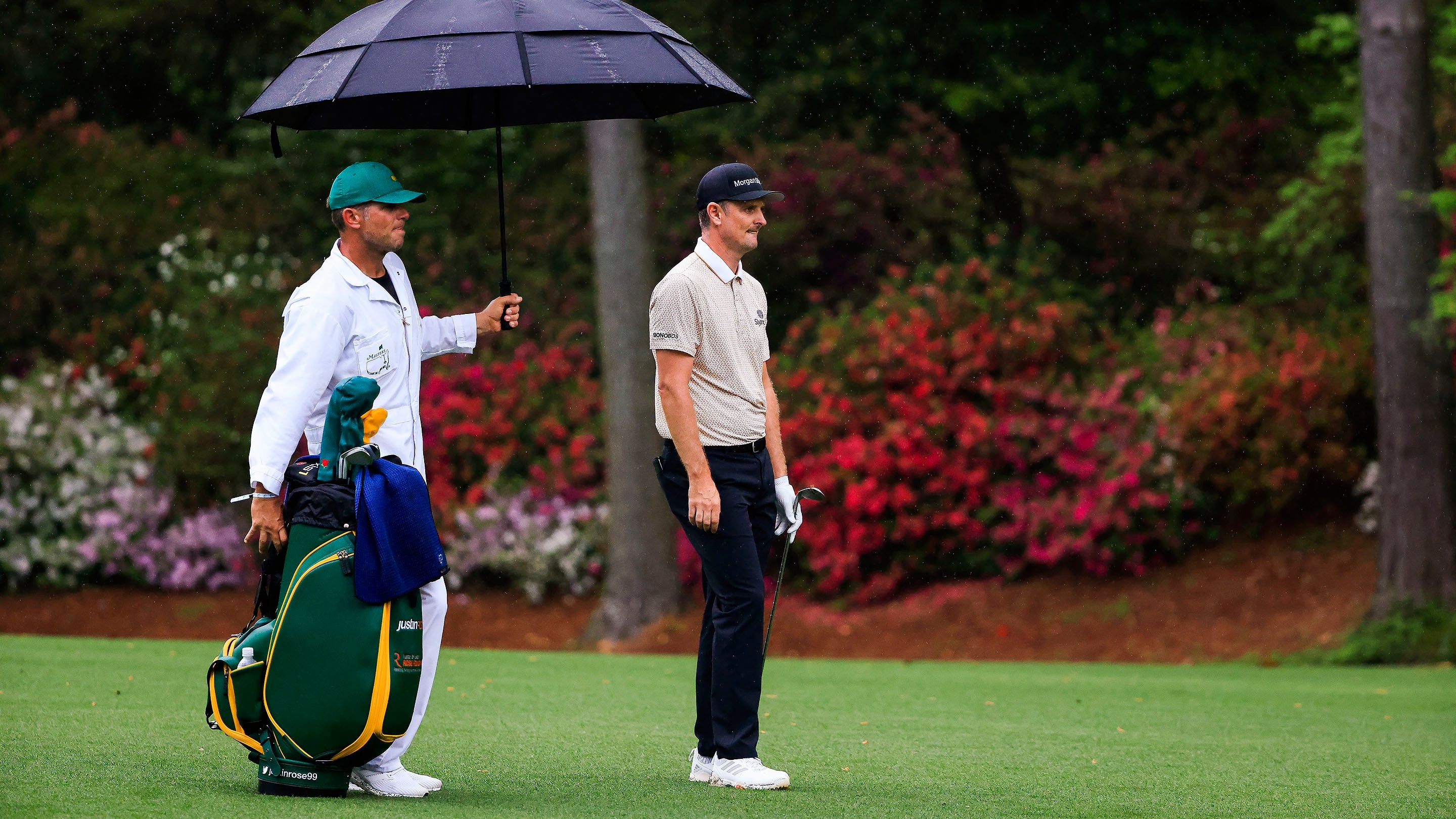 Justin Rose of England watches his shot on the No. 13 hole during Round 3 of the Masters at