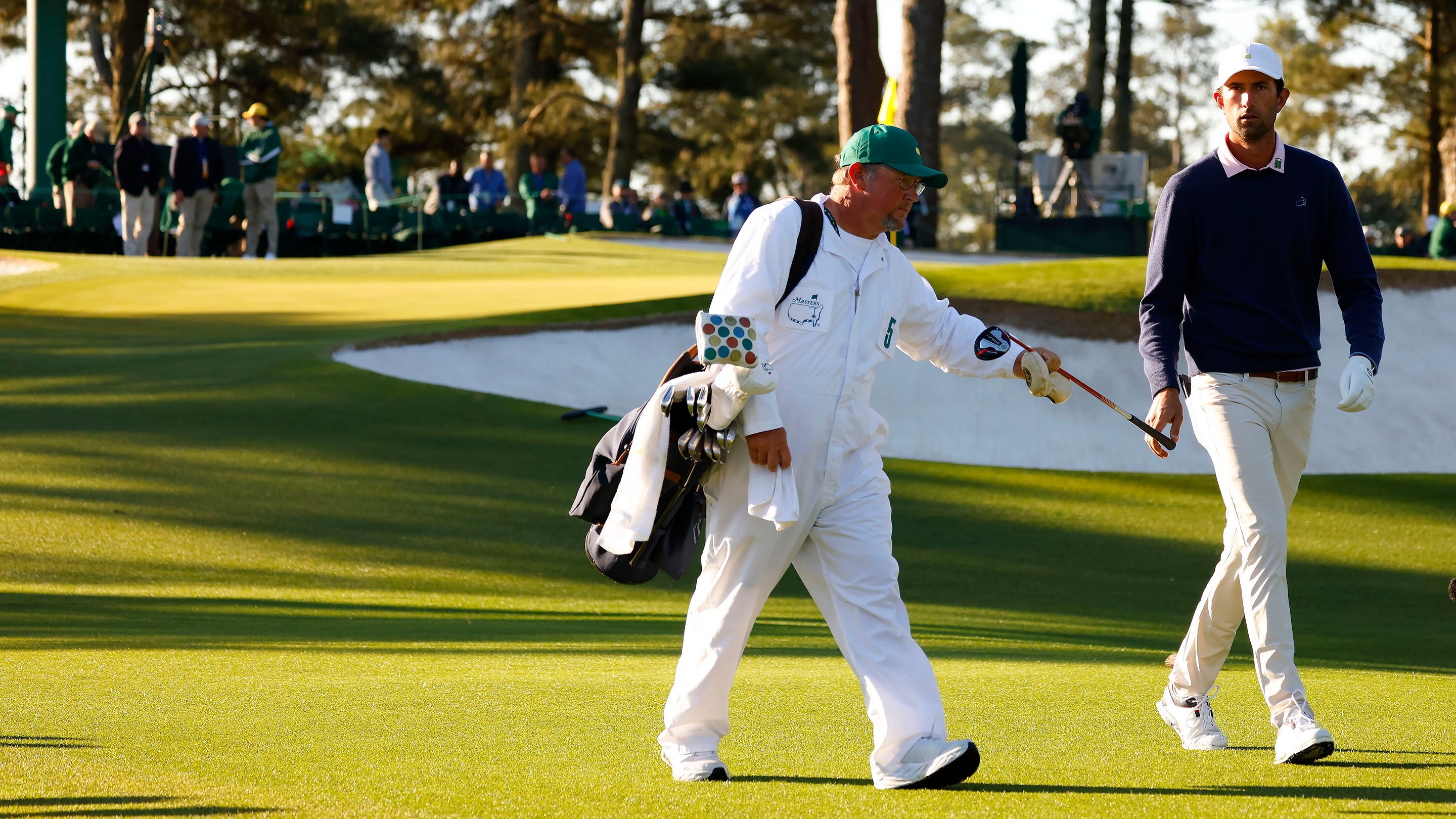 amateur-stewart-hagestad-hands-his-golf-club-to-his-caddie-john-a