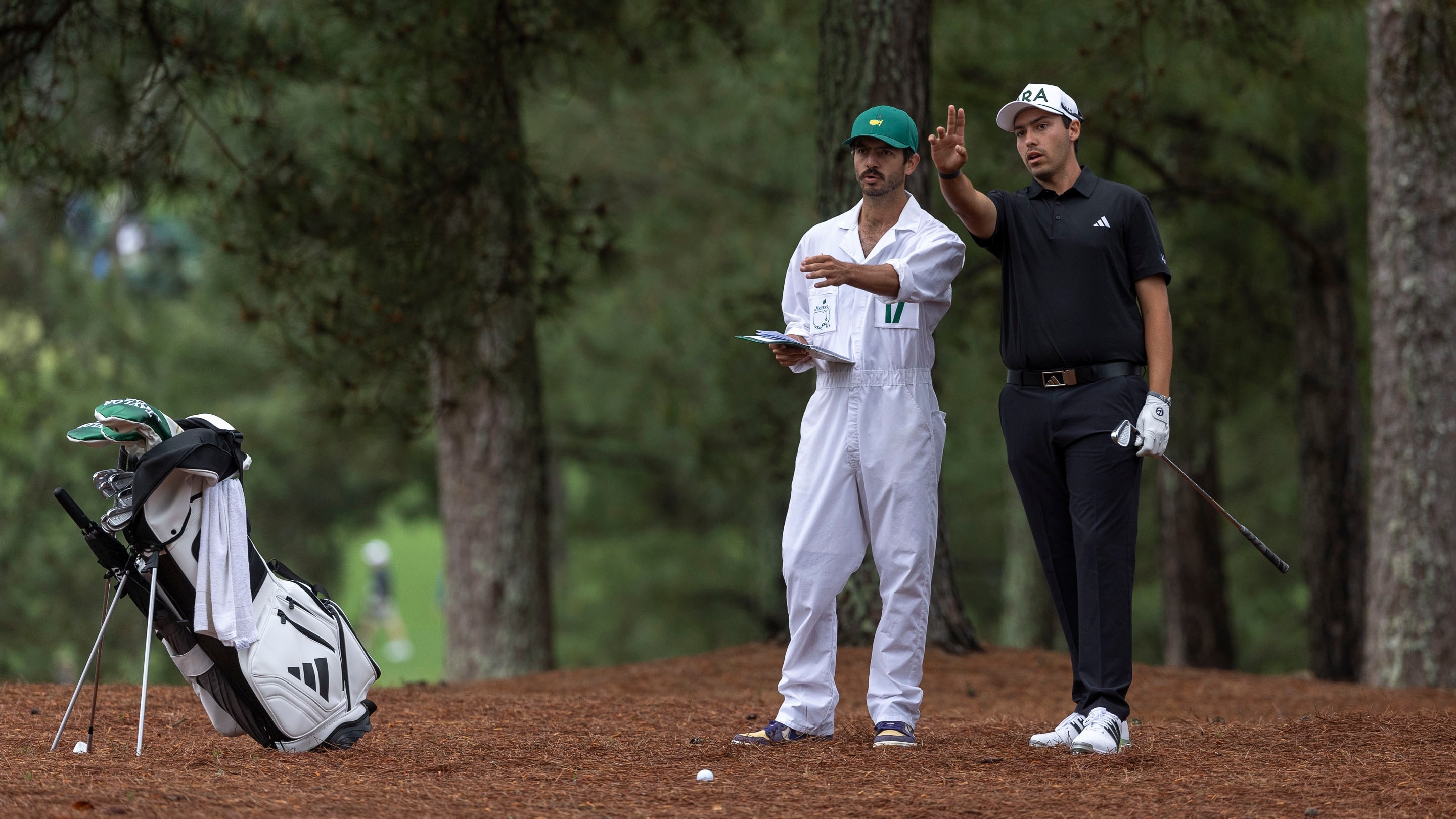 Amateur Santiago de la Fuente of Mexico with his caddie plays a stroke